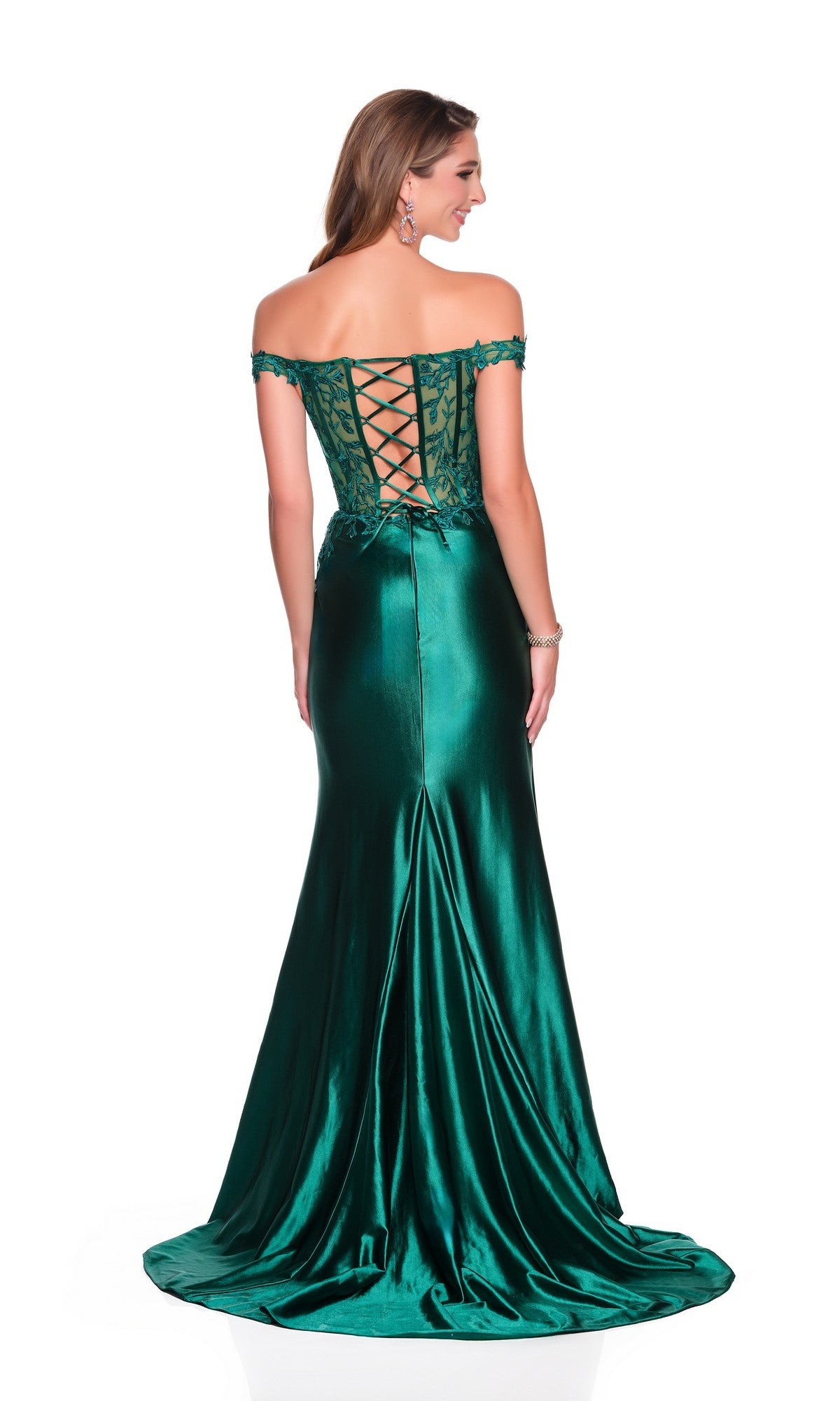 Woman in a floor-length emerald Dave and Johnny 12689 prom dress with an off-the-shoulder neckline, lace-up corset back, and slight train, standing against a white background.